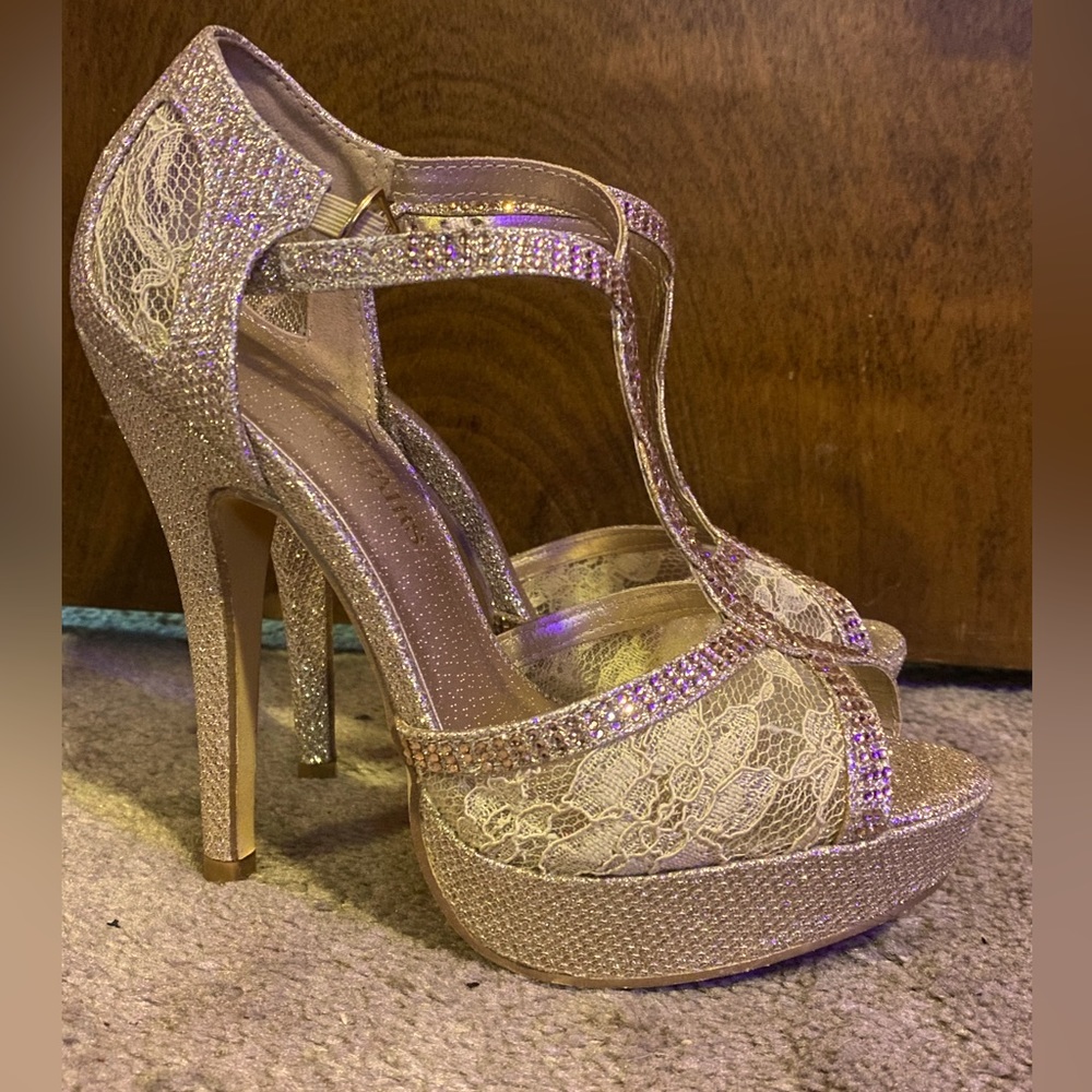 Gold platform heels. Size 6, only worn one night. Some black residue on bottom.